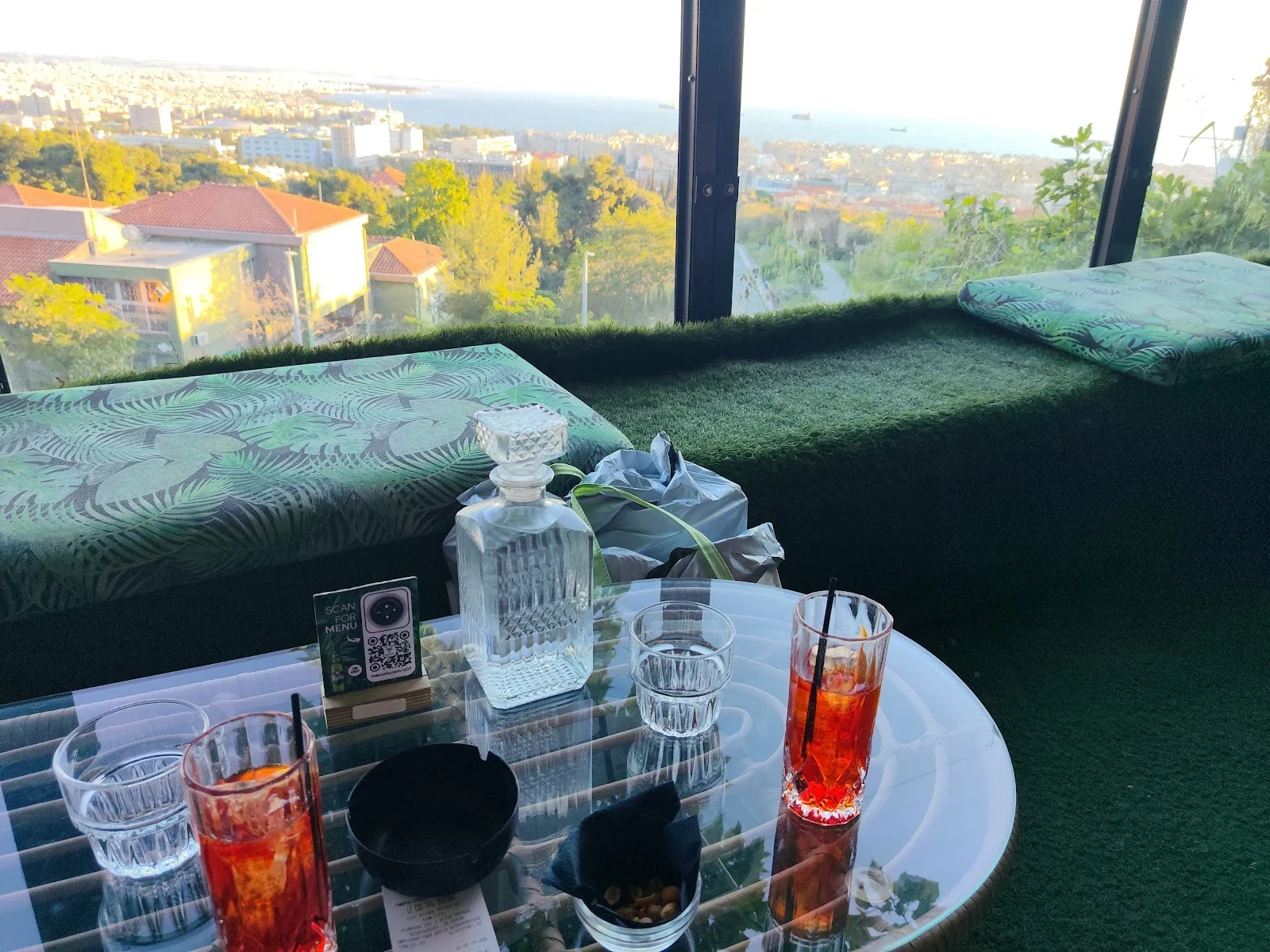 Cocktails on a terrace table at Le Coq overlooking the city and the Thermaic Gulf, eastern Thessaloniki