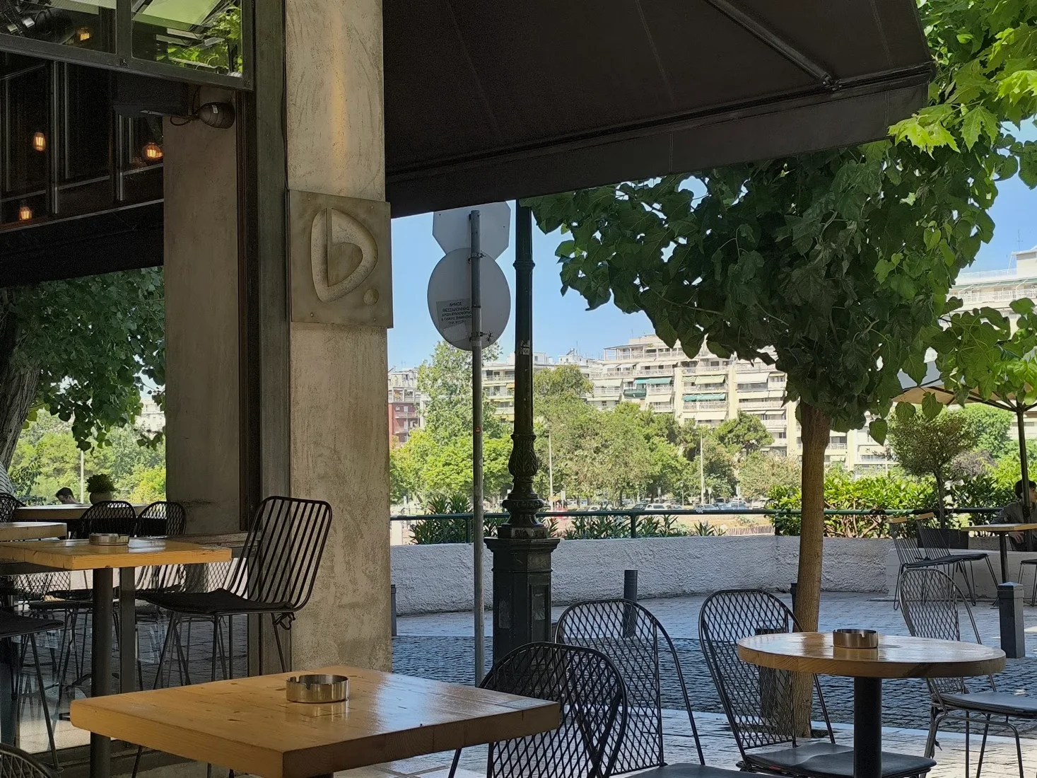 The leafy pavement terrace and wooden tables of The Blues Bar on Olympou in the upper old town, Thessaloniki