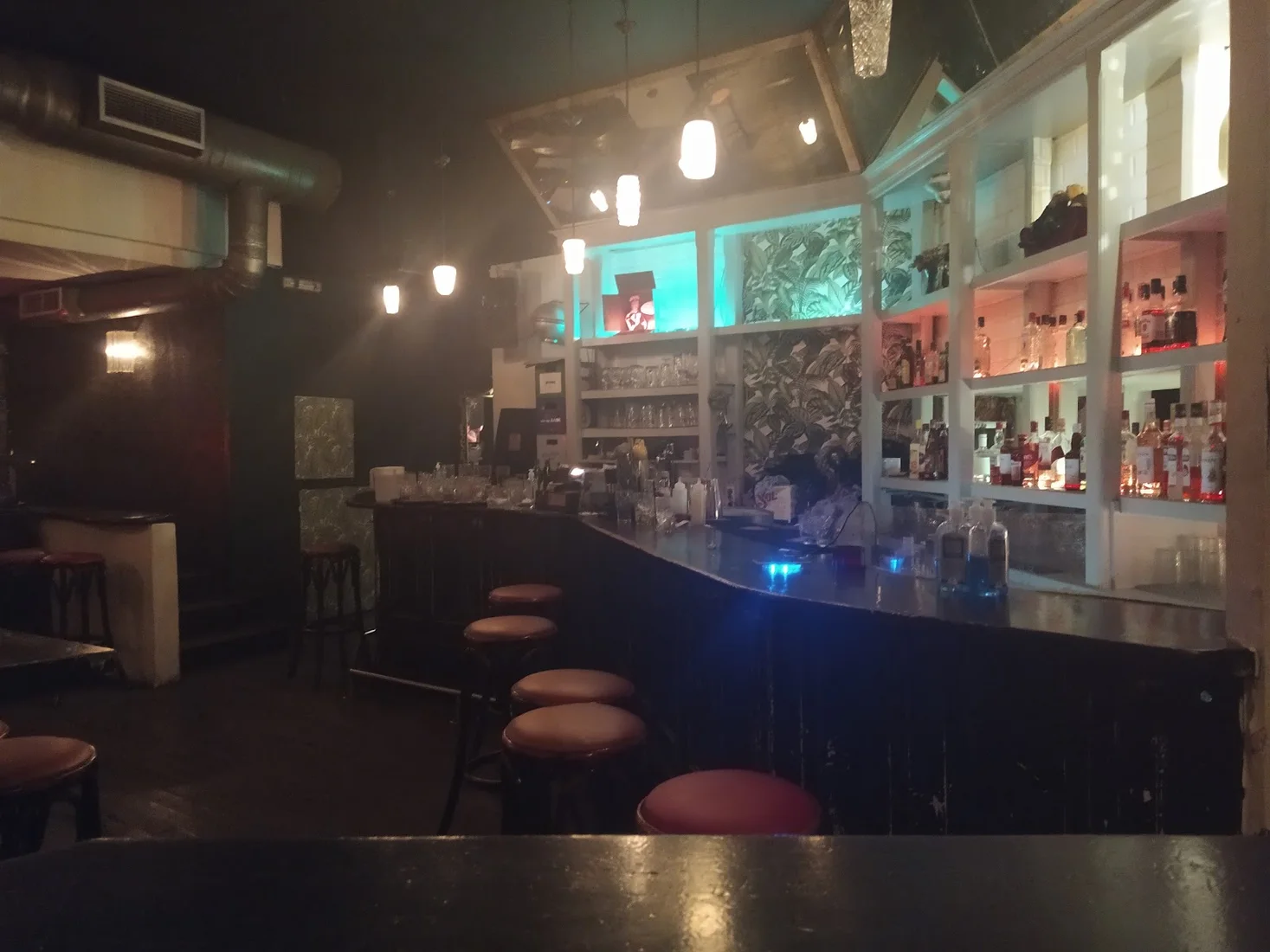 The dark, moody interior and backlit bottle shelves of The Residents cocktail bar near Navarinou, Thessaloniki