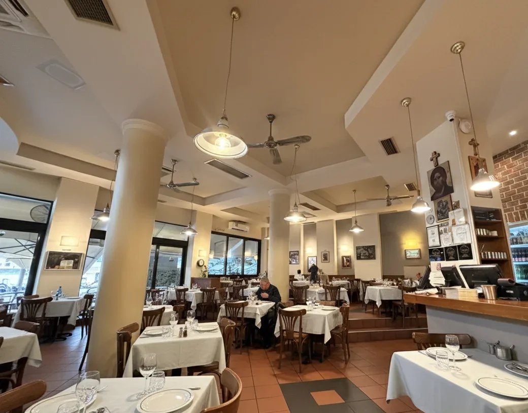 The white-tablecloth dining room of Diagonios 1977, a classic souvlaki restaurant near the White Tower, Thessaloniki