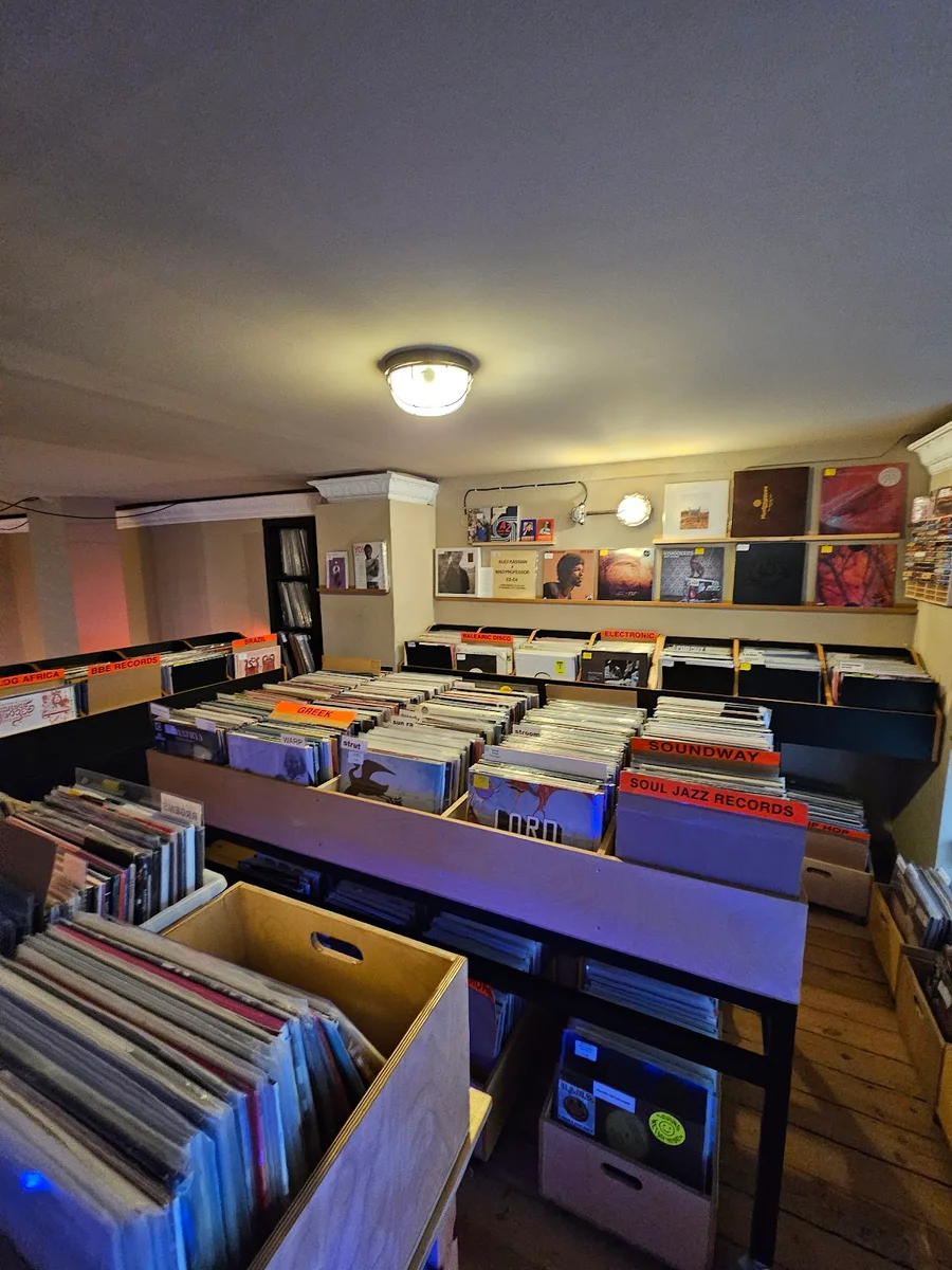 The open storefront of Father Coffee & Vinyl with blue stools, Thessaloniki