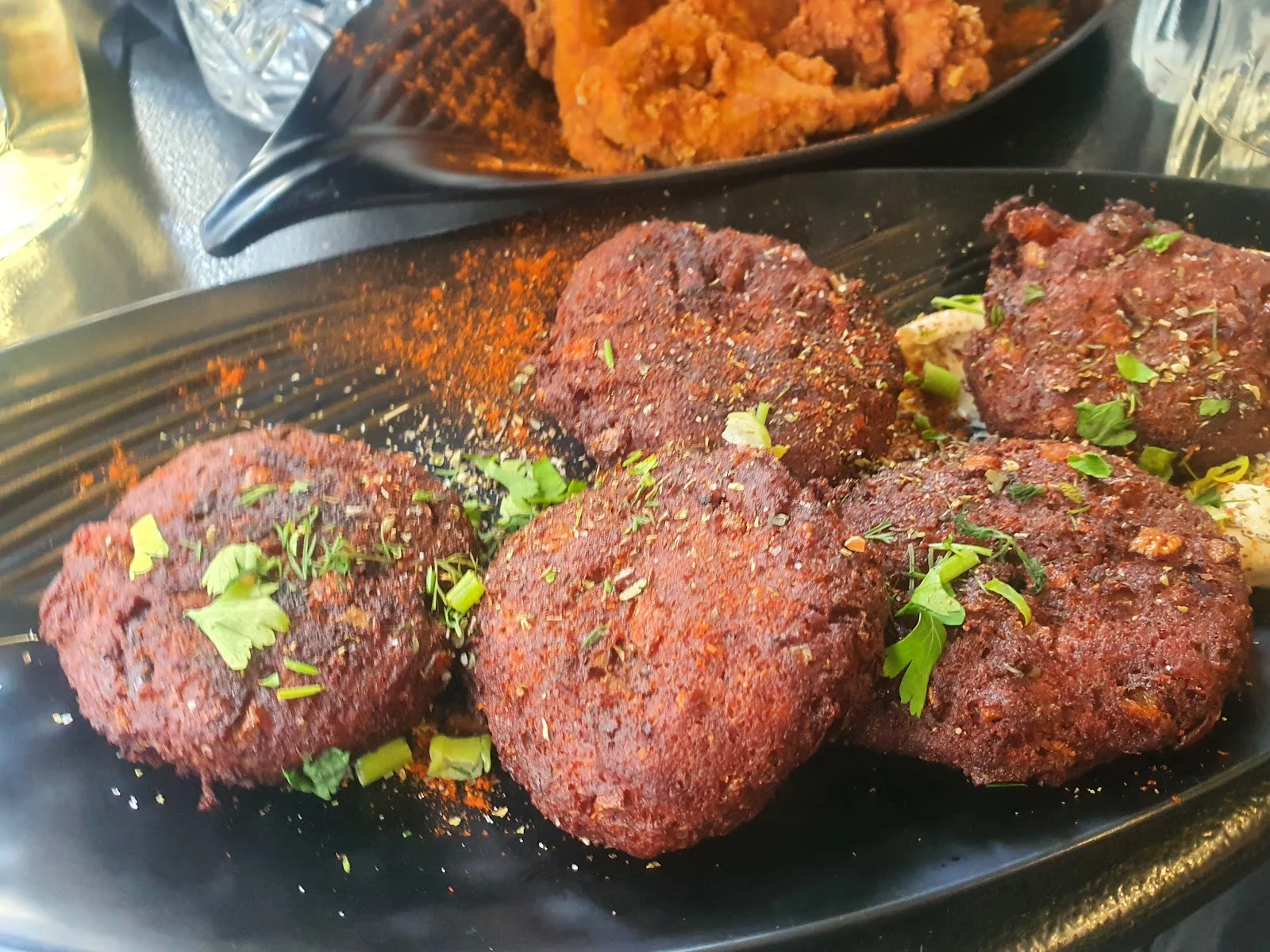 A plate of vegan beetroot keftedes (patties) dusted with herbs at Tarantoúla, Thessaloniki