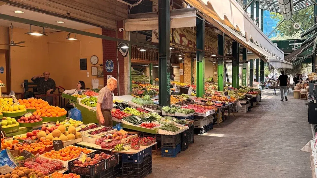 Colourful fruit and vegetable stalls under the arcade of a covered market in Thessaloniki