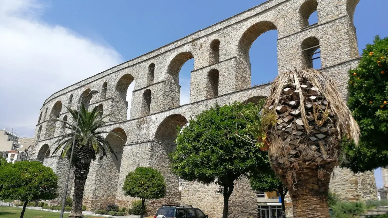 The arched stone Kamares aqueduct rising above the old town of Kavala