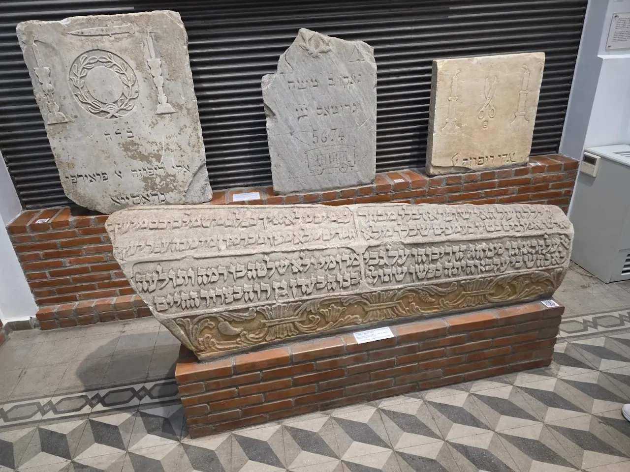 Carved marble tombstones with Hebrew inscriptions, rescued from Thessaloniki's destroyed Jewish cemetery and displayed in the Jewish Museum of Thessaloniki