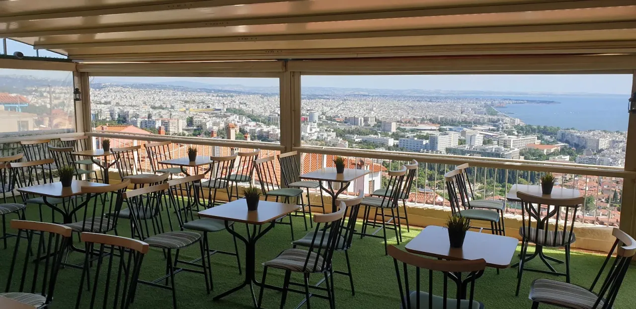 The covered terrace of Castra bar in Ano Poli looking out over the rooftops of Thessaloniki to the Thermaic Gulf