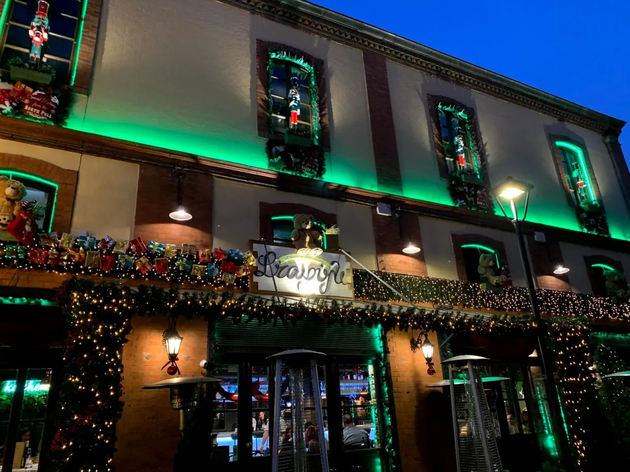 The green-lit exterior of Eightball rock club and live stage in Ladadika, Thessaloniki