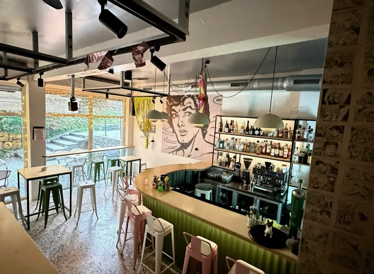 The pop-art comic-mural room and curved bar of Micro, a small all-day bar in the Ano Ladadika quarter of Thessaloniki