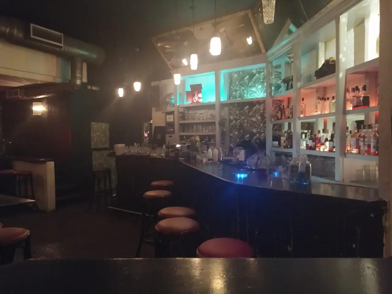 The dark, moody interior and backlit bottle shelves of The Residents cocktail bar near Navarinou, Thessaloniki